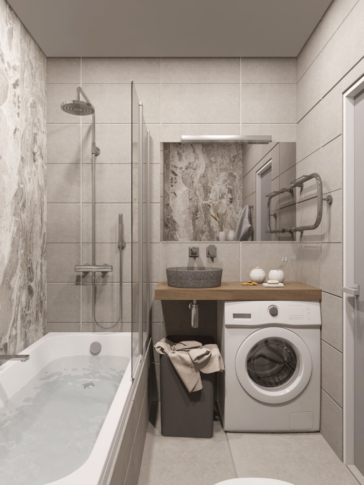Semleges színpaletta, márvány falburkolat, üveg kádparaván, mosógép fa mosdópult alatt, szürke kőmosdó, fix és kézi zuhany kis fürdőszobában