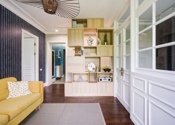 Csíkos tapéta, üvegezett és fehérre festett fa térelválasztás konyha és nappali között 51m2-es lakásban, világoskék előszoba falfestés