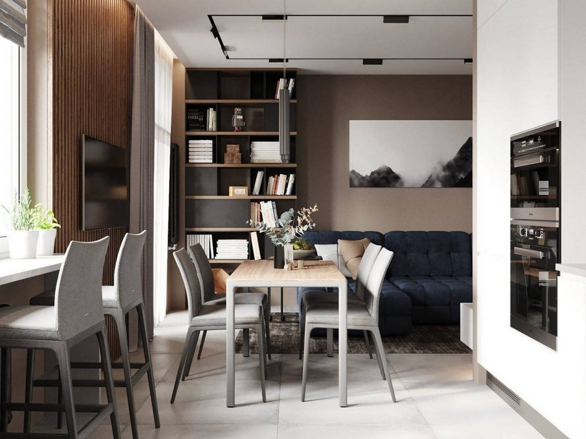 Szép semleges színárnyalatok és egy mélykék kanapé fehérrel kombinálva egyszobás lakásban