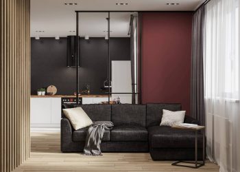 Férfi egyedi hangulattal berendezett modern otthona dizájnos és sötét elemekkel