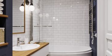 Kádparaván és íves, asszimetrikus fürdőkád, mintás padlóburkolat, sötétkék fal és épített fürdőszoba bútor